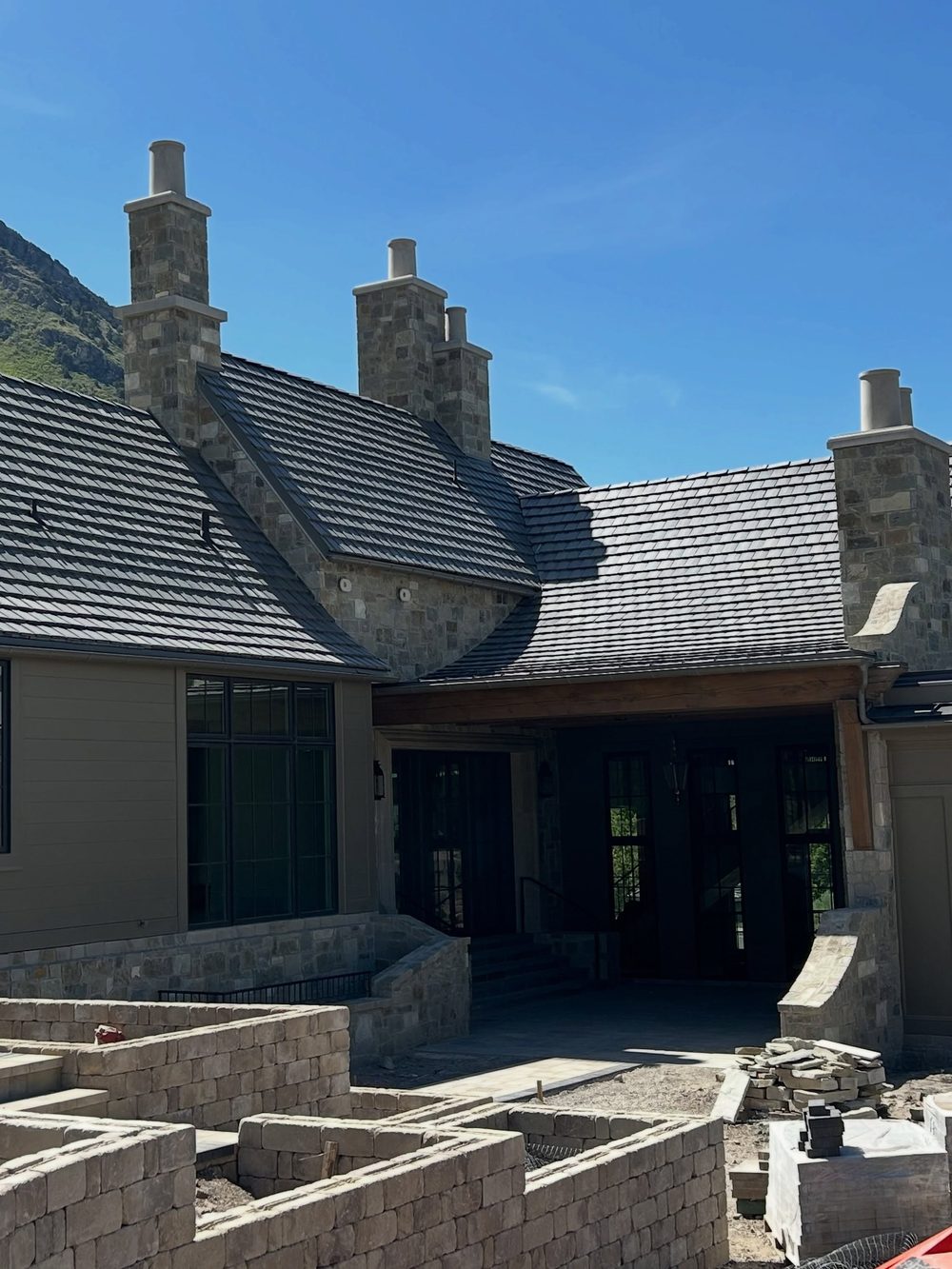 A new shingle roof and gutters on a red barn by Evolution Roofing
